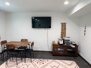a dining room with a table and a tv on a wall at Driftless Destinations in McGregor +8 photos