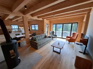 a living room with a couch and a stove at Schwarzwald Wellness Chalet in Todtnau