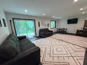 a living room with a couch and a television in it at Driftless Destinations in McGregor