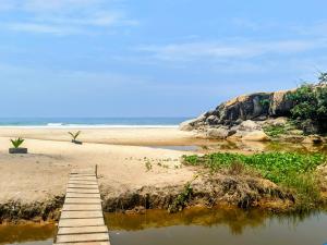 a wooden bridge over a beach with the ocean at Junto Al Mar - Chambre standard in San-Pédro