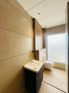 a bathroom with a sink and a toilet at Hotel Grand Elite- Ghaziabad in Ghaziabad