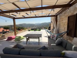 a living room with a couch and a hammock at Beitkamle in Batroûn