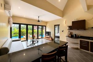 a kitchen and living room with a couch and a table at Tha Lane Bay Villas in Tha Lane Bay