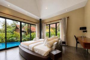 a bedroom with a bed and a desk and windows at Tha Lane Bay Villas in Tha Lane Bay +56 photos