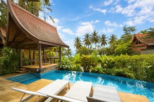 a swimming pool with chairs and a house at Tha Lane Bay Villas in Tha Lane Bay