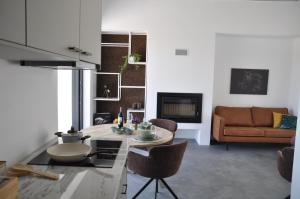 a living room with a table and a couch at Vale De Água Equestrian Resort in Odemira