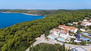 an aerial view of a house on the shore of a lake at Villas Marisol in Premantura