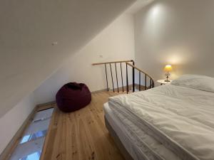 a bedroom with a bed and a backpack on the floor at duplex confort Le pre marty in Albepierre-Bredons