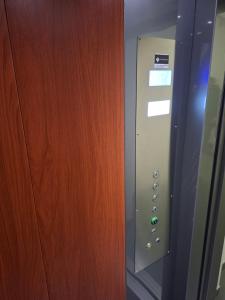 a close up of a wooden door with a control panel at Apartment Gonzales in Mostar