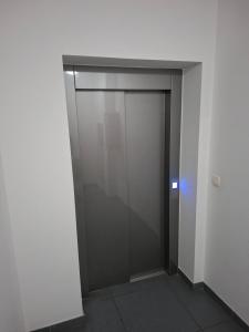 a elevator door in a building with a blue light at Apartment Gonzales in Mostar +8 photos