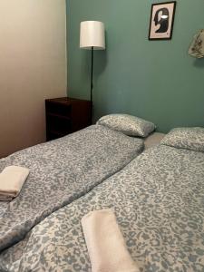 a hotel room with two beds and a lamp at AH-REMINI GARDEN Home in Siófok
