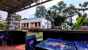 a patio with a table and chairs and a building at The Serene Maskani in Moshi