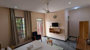 a living room with a table and a tv at The Serene Maskani in Moshi