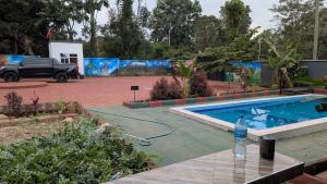a car is parked next to a swimming pool at The Serene Maskani in Moshi
