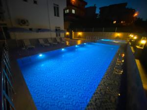 a swimming pool at night with blue lights at YILDIZ APART in Demre