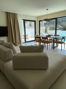 a living room with a couch and a dining room at Villa Artemis III in Žman