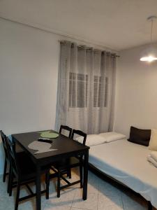 a room with a table and a bed and a table and chairs at Platamon house in Platamonas