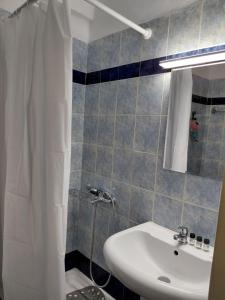 a bathroom with a sink and a shower at Platamon house in Platamonas