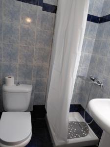 a bathroom with a toilet and a sink and a shower at Platamon house in Platamonas +4 photos