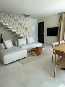 a living room with two white couches and a table at Villa Artemis III in Žman