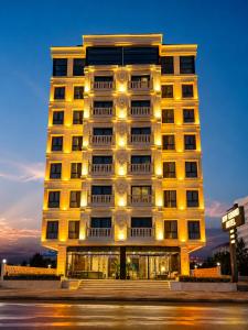 a tall building with lights on the side of it at Midyat Bay Grand Hotel in Midyat
