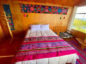 a bedroom with a bed in a room with a window at Islas Chimu in Puno +22 photos