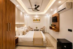 a hotel room with a bed and a table at Hotel Grand Villa Suites Near Delhi International, IGI Airport in New Delhi