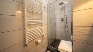 a bathroom with a shower with a glass door at Pearl Home in Békéscsaba +16 photos