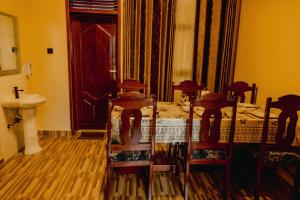 a bedroom with a bed and a sink and a mirror at Sabyinyo Crest in Cyuve