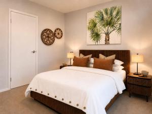 a bedroom with a large bed and two lamps at One Mile Retreat - Ocean View 3 Bedroom Retreat in Anna Bay