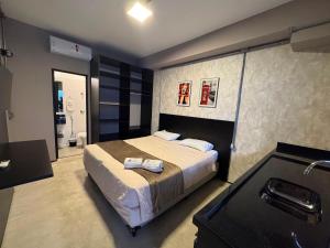 a bedroom with a bed with two towels on it at Add Hotéis Mascote in São Paulo +27 photos