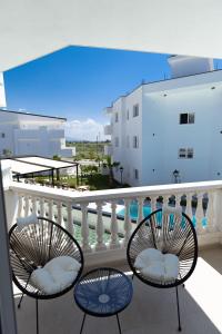 two chairs on a balcony with a view of a building at Sirena Garden Resort in Tale