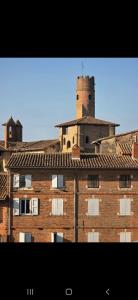 a large brick building with a tower on top of it at Tour Médiévale Unesco in Albi