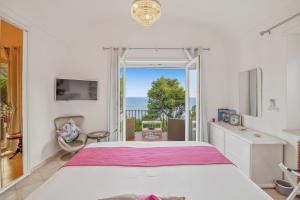 a bedroom with a bed and a view of the ocean at MARVELOUS CAPRI - Sea View Villa in Capri