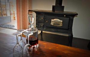 two glasses of wine sitting on top of a wooden table at Shallow Pig Cottage in Parys