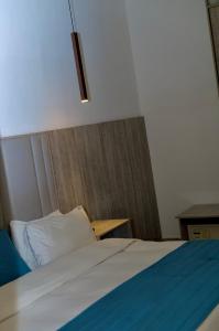 a bedroom with a bed with a pillow and a table at Tipson Apartments in Bamgbose