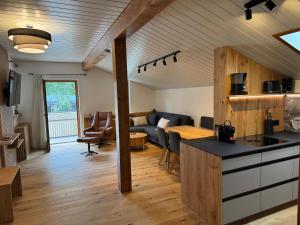 a kitchen and living room with a couch at Appartements Lenzikopf in Brand