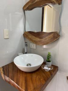 a bathroom with a white sink and a mirror at BlackPoint in Ballenita +55 photos