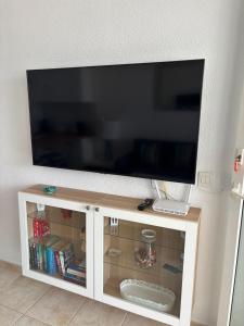 a flat screen tv on top of a white cabinet at 42 Guacimeta Club in Los Pocillos