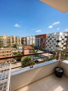a balcony with a view of a city at SiMar Apartment Tirana in Kashari