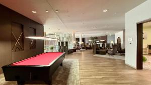 a living room with a pool table in the middle at Bayside in Scharbeutz