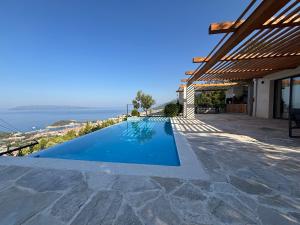 a swimming pool in a house with a view of the ocean at Villa Kostela Makarska in Makarska