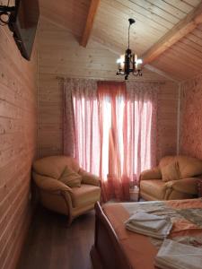 a room with a bed and a couch and a window at Casa dos Cortinhais 2 in Oliveira de Frades