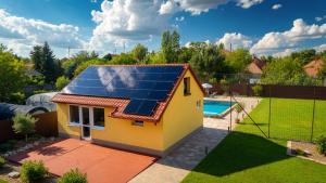 a small house with solar panels on the roof at Pearl Home in Békéscsaba
