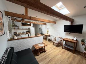 a living room with a couch and a tv and a table at SPOKO Chatka in Rypin +4 photos