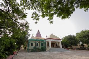 a green and white building with two towers at Omji Ashram - Maa Anandmayi in Vrindāvan +19 photos