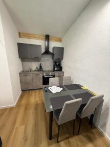 a kitchen with a table and chairs in a room at Apartment inn Austria in Pfunds