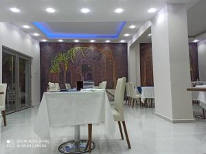 a dining room with a white table and white chairs at EnkayaHotel in Nicosia