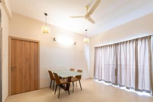 a dining room with a table and chairs at viyan stays in Coimbatore