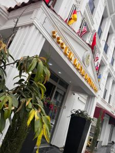 a white building with a sign on the front of it at EnkayaHotel in Nicosia